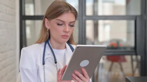 Female Doctor Using Tablet in Hospital Setting