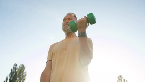 Bottom View Elderly Caucasian Man Training Sport with Dumbbells Physical Activity Muscular Sportsman