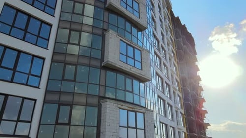 High Residential Apartment Building with Monolithic Frame and Glass Windows Under Construction Real
