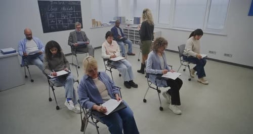 Adults in Classroom Taking Notes During a Class