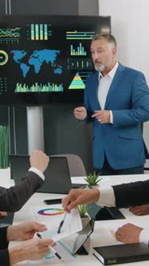 Business Team Meeting Analyzing Data in Modern Office