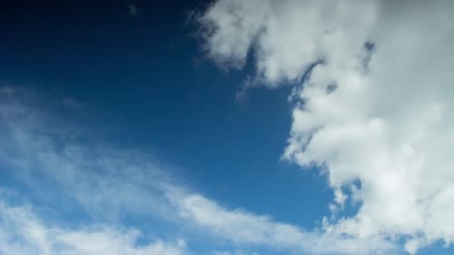 Timelapse White Clouds in the Blue Sky Fly in Different Directions