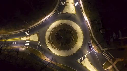 Rotating Aerial Timelapse Birdseye Traffic Circle at Night in the City With Cars and Lights