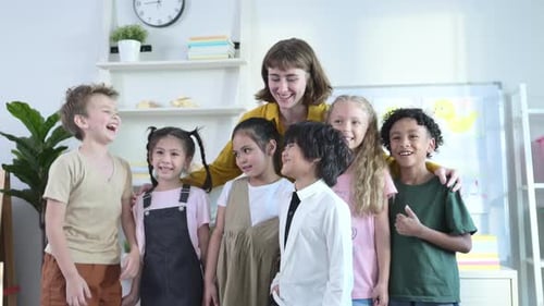 Happy Children and Teacher Smiling in Classroom