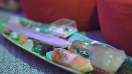 Collection of various spiritual crystals placed on a plate that looks like a leaf slow motion