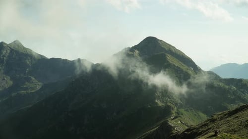 Cloud Slowly Moving Through Mountain Peaks