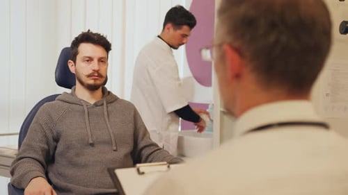Young Adult Patient Consulting with Doctor in Clinic