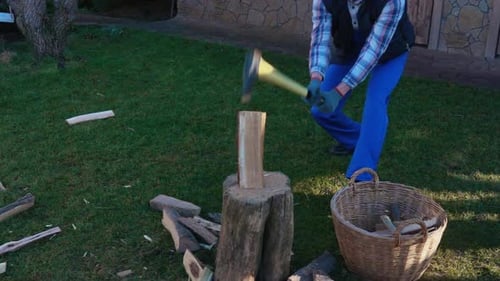 Winter Preparations With a Couple Chopping Firewood for Warmth and Sustainability
