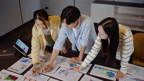 Colleagues Collaborate in Modern Office Analyzing Business Data