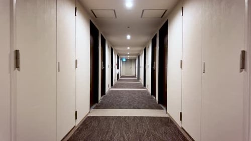 POV walking along Empty hotel corridor with doors and carpet