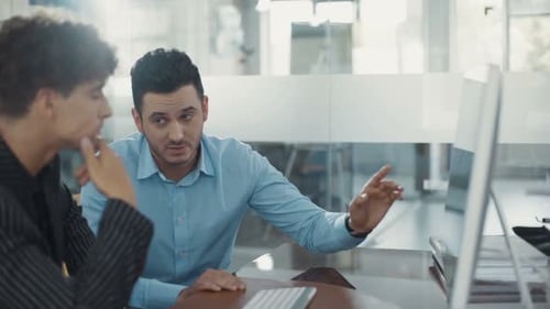 Business Partners are Discussing Use Computer Speak in a Modern Office Shot on RED Epic Camera Shot