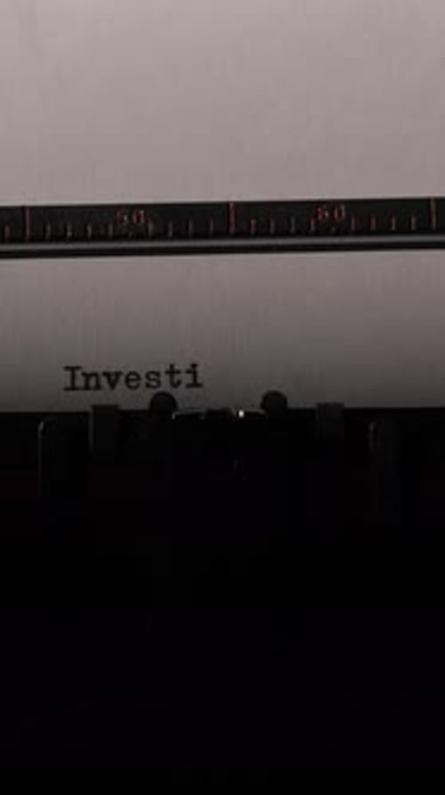 Vintage Typewriter Types the Word Investigation on Paper