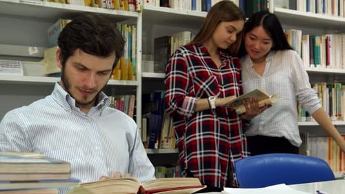 Focused Male Student Engrossed in Reading at the Library