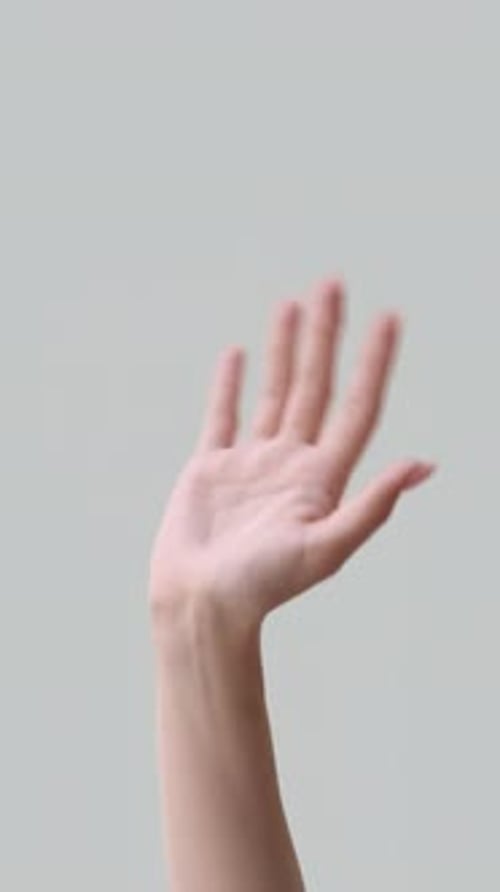 Hand Waving on Gray Background