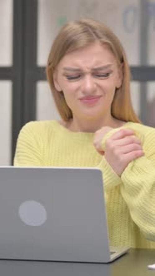 Woman with Wrist Pain Using Laptop Computer