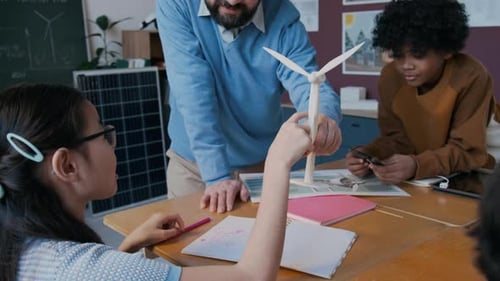 Teacher Explains Wind Turbine to Students in Classroom