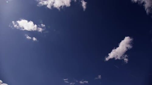 Clouds Slowly Drifting Across a Blue Sky