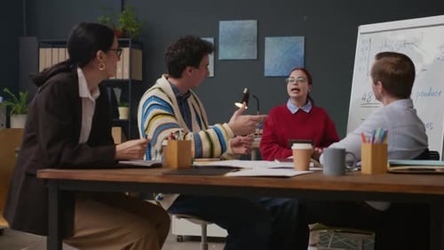 Colleagues Discussing Business Tasks and Plans in Modern Office