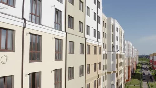 Tilt Up Drone View of Facade of Modern Typical New Residential Building with Light Walls in