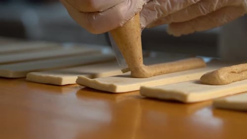 Baker Puts Filling on Rectangular Pieces of Dough