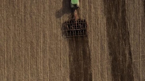 Top View or Aerial Drone View on Tractor Plows the Agricultural Field Agricultural Concept Full