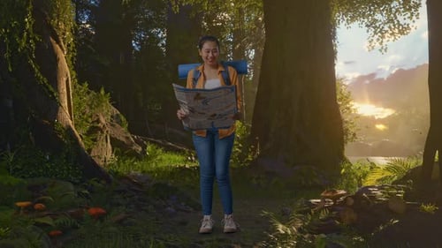 Asian Female Hiker Looking At The Map Then Smiling While Exploring Forest Nature