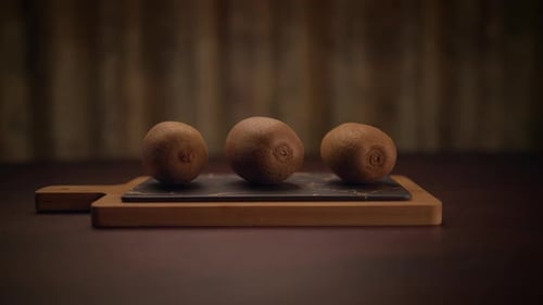Kiwi Fruit Sitting on Cutting Board on Table