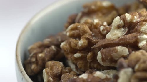 Walnuts Close-Up 4K Shot of Nuts Rotating. Nuts Spinning In Bowl. Protein Plant Based Raw Vegan Food