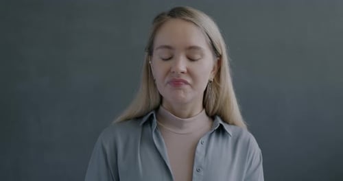 Woman Giving Thumbs Down Gesture in Close-Up