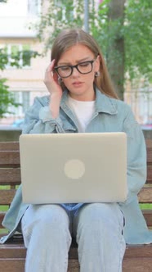 Vertical Video, Woman with Headache Using Laptop in Park