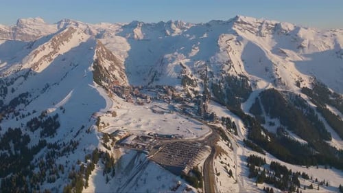 Snow Covered Mountain With A Ski Resort Below The Ridge