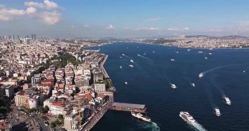 Aerial Pullback Reveals Karakoy Ferry Terminal. Bosphorus Strait Istanbul Turkey on Summer Day with