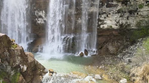 Beautiful Waterfall Flowing Down Rocky Cliffside