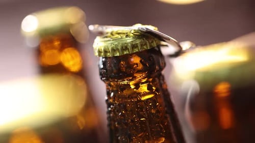 Opening a cold beer bottle with opener