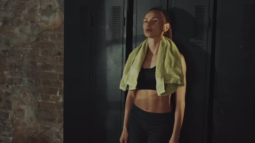 Woman Overwhelmed After Workout in Locker Area