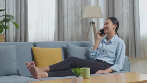 Smiling Woman Chatting on Phone at Home