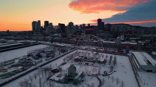 aerial shot around Montreal City Ferris Wheel in the old port at sunset during winter, Montreal city