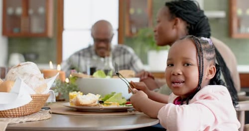 Family Mealtime: Child Smiles at the Camera