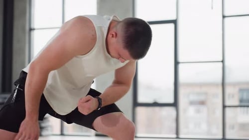 Gym Bro Performing Side Lunge Stretch Modern Fitness Studio With Windows