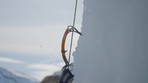 Slow Motion Close Up Shot Of Climber Hitting Axe Hard In Iced Snow