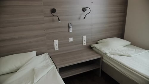 The bed is in the hotel. A two-bed room waiting for guests. Two made-up beds in the apartment