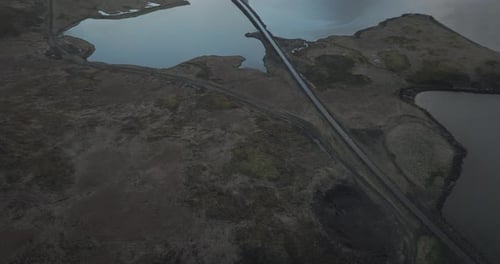 Aerial view of Kirkjufell Lake with scenic mountain landscape and road, Iceland.