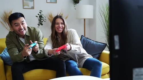 Couple Playing Video Games at Home Together