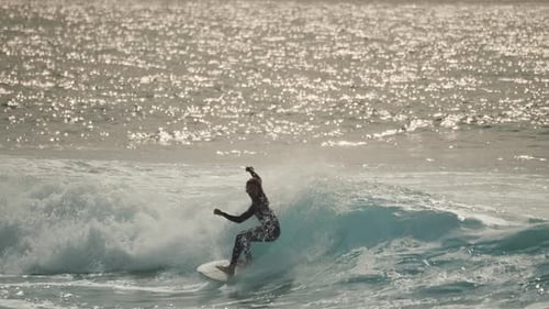 Surfer in surfing suit riding the perfect ocean wave
