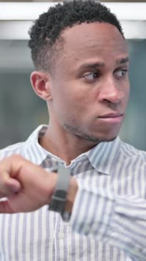 Anxious Man Checks Smartwatch, Looks Around Waiting
