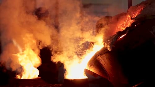 Pouring of hot liquid metal from a crucible into a mould in a foundry in Bahrain
