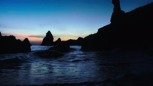Rocky empty beach during twilight