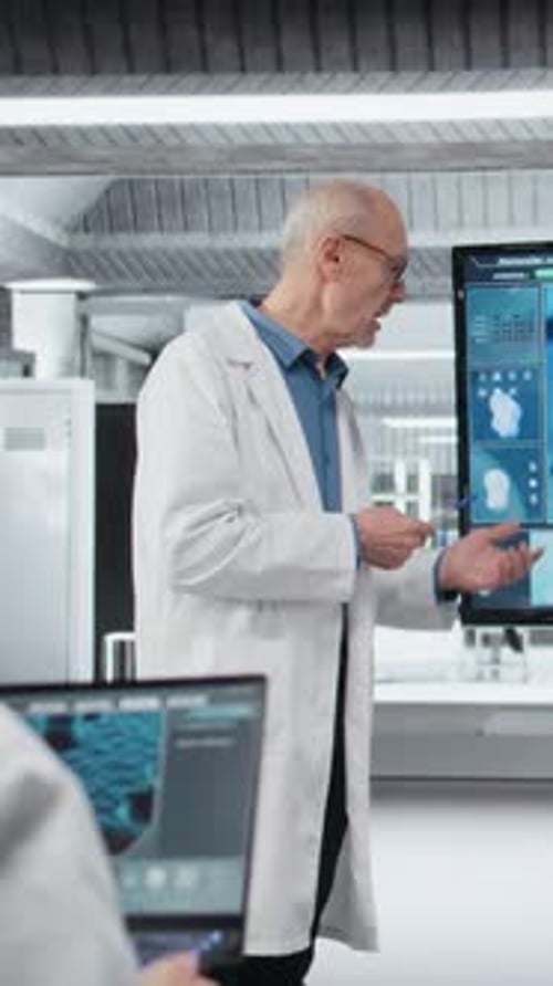 Vertical Video Senior Scientist in Lab Presents Innovative DNA Sequencing Project to Colleagues