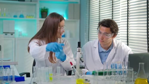Scientists Working in a Lab with Test Tubes
