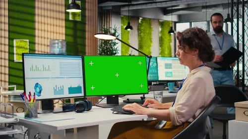 Executive Assistant Analyzing KPI Metrics on Computer Monitor with Mockup